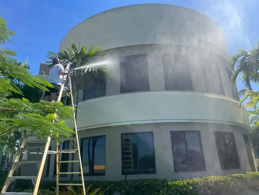 Eco-Friendly-Roof-Cleaning-Pressure-Washing man pressure washing building